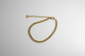 Curb Chain Bracelet - Gold curb chain bracelet with lobster clasp overhead view